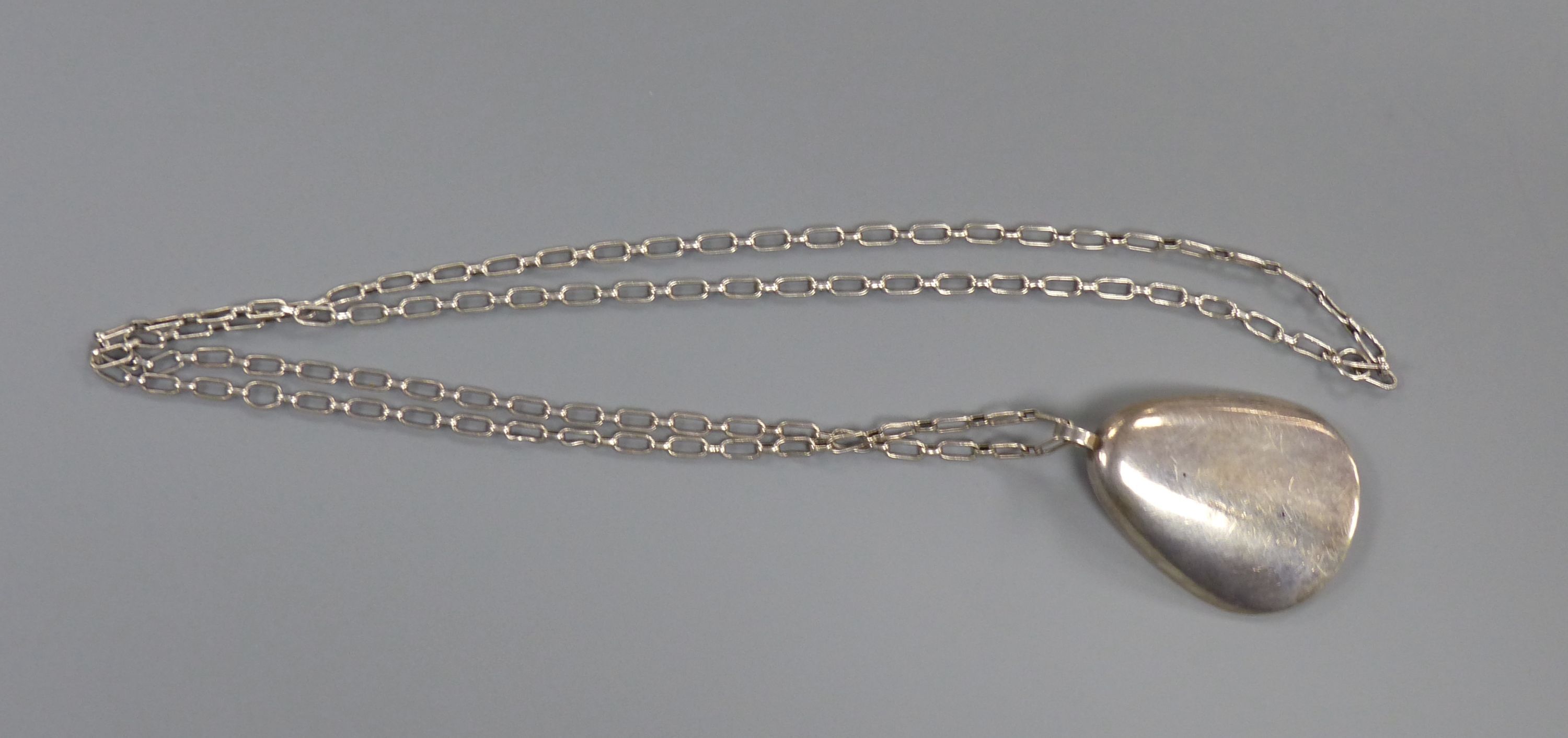 A 1960's Nanna & Jorgen Ditzel for Georg Jensen sterling oyster shell pendant, 60mm, design no 328, on a white metal chain, 84cm